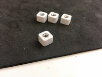 Spacers, fresh from the 3d printer, nuts already inserted.
